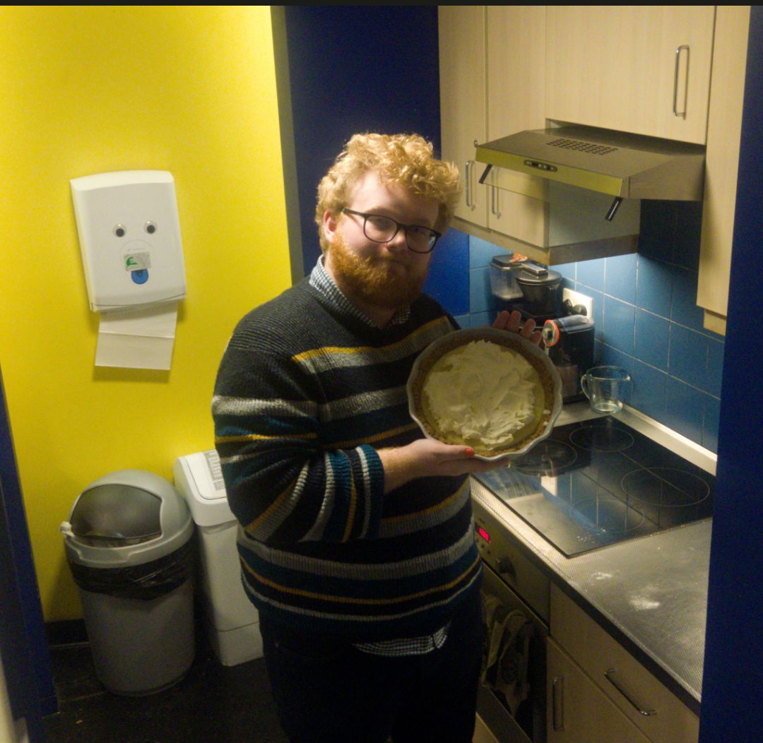 Ben holding a key lime pie alluringly.
